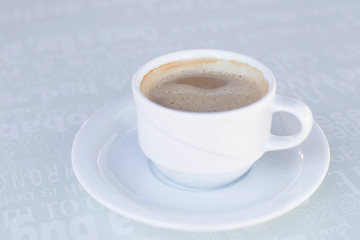 Fototapeta premium One cup of coffee on the plate on the table