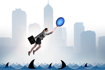 Businesswoman flying holding balloon
