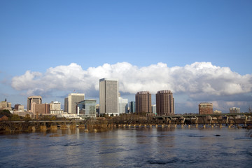 Fototapeta na wymiar Richmond, Virginia cityscape skyline with blue sky and clouds on the James River.
