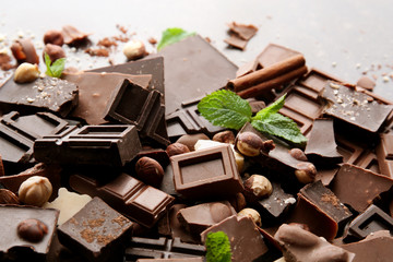 Heap of broken chocolate pieces on table