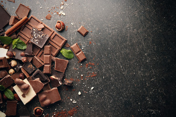 Heap of broken chocolate pieces on table