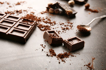 Broken chocolate pieces with spoon on table