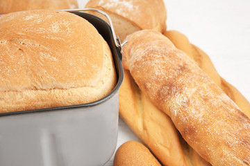 Freshly baked loaf in bread machine pan, closeup