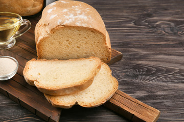 Loaf baked in bread machine on wooden table