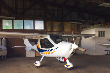 Small aircraft in a hangar