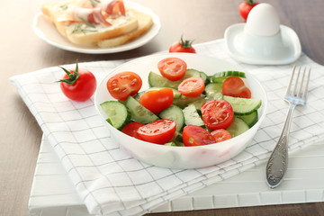 Plate with tasty salad for breakfast on table