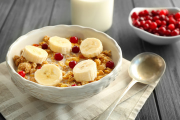 Tasty oatmeal with banana for breakfast on table