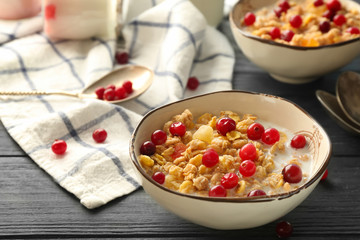Tasty oatmeal with cranberry for breakfast on table