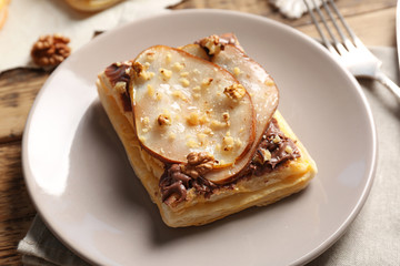 Plate with delicious pastry and flatware, closeup