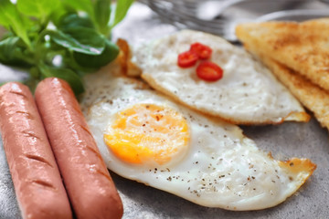 Delicious breakfast with over hard eggs, closeup
