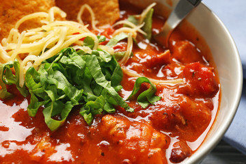 Delicious chili turkey with herbs and grated cheese, closeup
