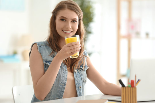 Weight loss concept. Beautiful young woman sitting at table and drinking healthy delicious smoothie