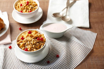 Healthy breakfast with muesli and yogurt on table