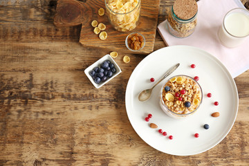 Healthy breakfast with muesli and berries on wooden table