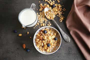 Breakfast cereal with berries and milk on table