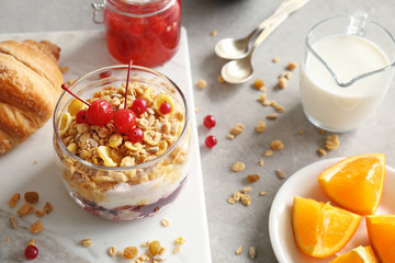 Healthy breakfast with muesli, berries and yogurt on table