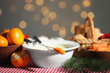 Bowl with cheese fondue on festive table