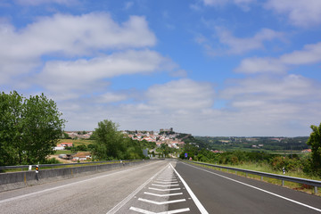 Tar road and the medieval city of Obidos on background. Portugal