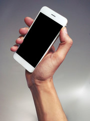 a hand holding a phone in a blank background