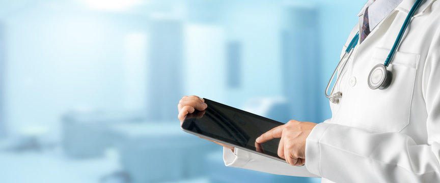 Male Doctor Using Tablet Computer.