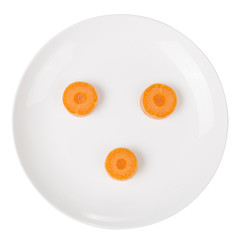 Carrot slice in a white plate on the white background.
