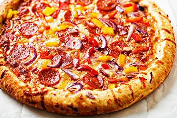 Barbecue pepperoni, red pepper and red onion pizza