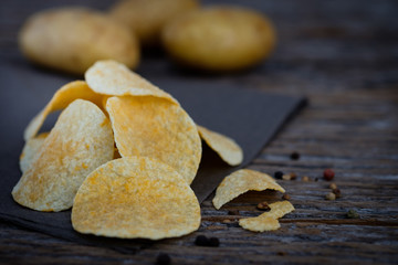 Potato chips on wooden background Choose focus point.