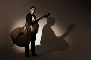 Fototapeta premium Classical musician studio portrait with double bass