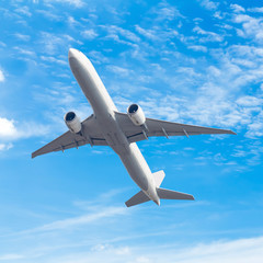 commercial airplane flying against blue sky background with clipping path