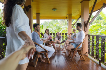 Woman Hold Man Hand Enter Summer Terrace With People Group Talking, Friends Outdoors Happy Smiling...