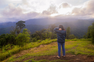 Fototapeta premium freedom girl with hands up in the mountains against sun