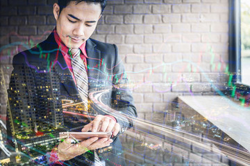 Fototapeta na wymiar young and smart business man in suit using tablet with free copyspace for your ideas text