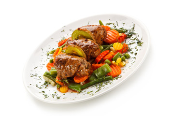 Wrapped pork chops and vegetables on white background 