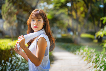 The girl is jogging with white cloth.	