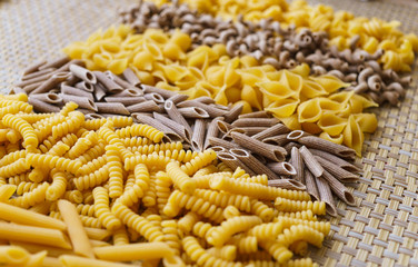 noodles, pasta of different kinds, scattered on the table.