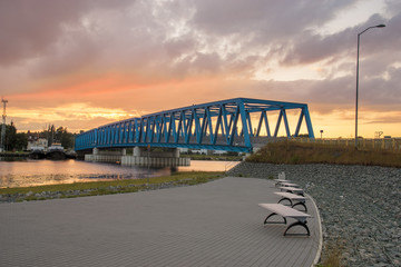 Steel bridge over the river in the industrial part of the city of Szczecin