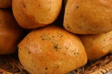 Homemade buns with garlic and dill on wooden table. Selective focus.