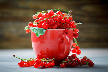 Ripe red currants on a wooden table.