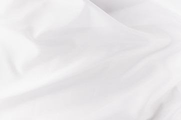 Obraz premium White smooth luxury silk or satin texture with liquid waves for wedding background.