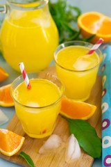 Fototapeta na wymiar Sweet orange drink with ice and mint leaves