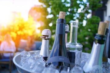 Wine bottles set in bucket, NYC rooftop