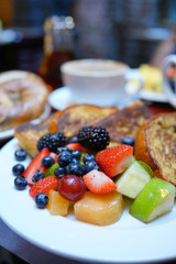 French toast with fruit salad set on restaurant table, NYC