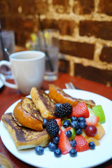 French toast with fruit salad set on restaurant table, NYC