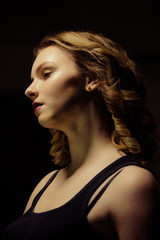 Attractive girl with red lips. Dark background.