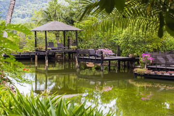 Fototapeta na wymiar Pavilion for relaxing on a pond in a tropical garden, Thailand