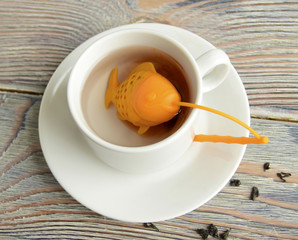 Strainer for tea. The strainer is made in the form of fish. In a strainer there is a tea. The strainer is made of silicone.