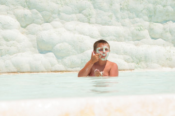 The child swims in the Pamukkah tram. Wellness baths.