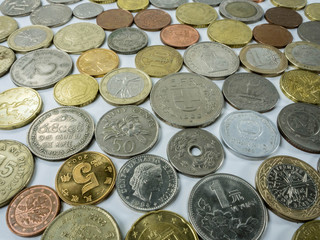 Various types of coins on white background as financial concepts.