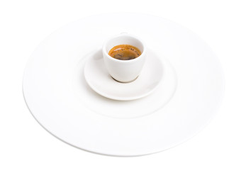 Espresso cup on a plate.