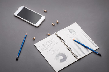 Creative sketch in spiral notepad with laptop on desk. Business starup plan.